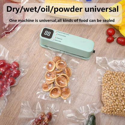 Vacuum sealer machine on a table with sealed food items including fruits, cookies, and grains.